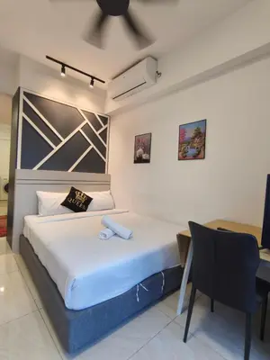 a bedroom with a bed with a ceiling fan at Luxe Colony By Urban Haven in Kuala Lumpur