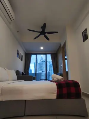 a bedroom with a bed and a ceiling fan at Luxe Colony By Urban Haven in Kuala Lumpur