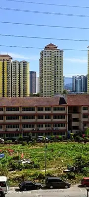 a large building in front of some tall buildings at Hot Spring Residential in Kuala Lumpur