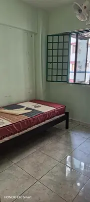 a bed in the corner of a room at Hot Spring Residential in Kuala Lumpur