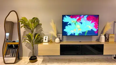 a flat screen tv sitting on top of a wooden entertainment center at Eaton Residences KLCC- JD World Homestay in Kuala Lumpur