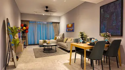 a living room with a couch and a dining room at Eaton Residences KLCC- JD World Homestay in Kuala Lumpur