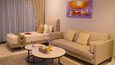 a living room with a couch and a bed at Eaton Residences KLCC- JD World Homestay in Kuala Lumpur