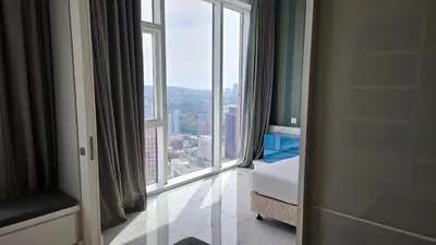 a bedroom with a large window with a view at Platinum Executive Suites Kuala Lumpur in Kuala Lumpur