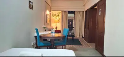 a dining room with a table and blue chairs at Times square in Kuala Lumpur
