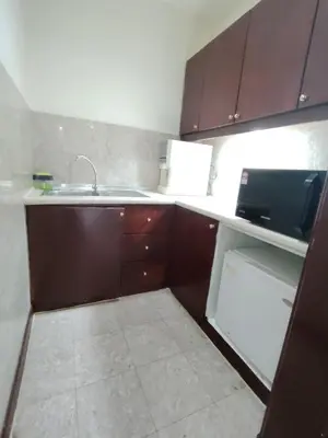 a small kitchen with a sink and a microwave at Kuala Lumpur City Apartment Times Square in Kuala Lumpur