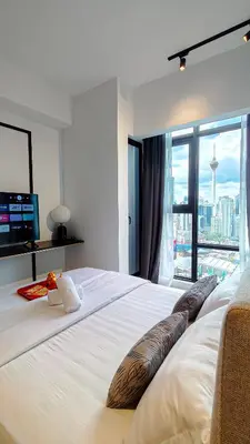 a bedroom with a large white bed with a large window at Axon Residence Bukit Bintang by Mia in Kuala Lumpur