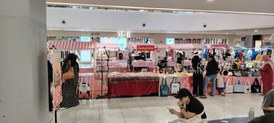 a woman sitting in front of a clothing store at City Suites At Quill Residence KL in Kuala Lumpur