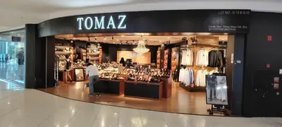 a woman standing in front of a clothing store at City Suites At Quill Residence KL in Kuala Lumpur
