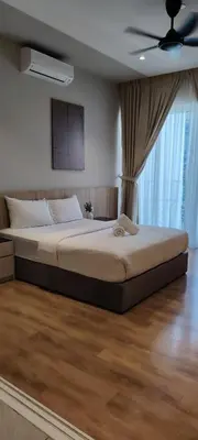 a large bed in a bedroom with a ceiling fan at City Suites At Quill Residence KL in Kuala Lumpur