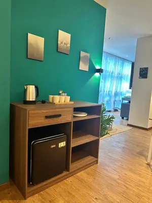 a kitchen with a wooden cabinet with a sink at Premium One Bedroom Condo at Bangsar Trade Centre in Kuala Lumpur
