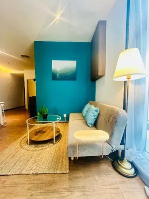 a living room with a couch and a table at Premium One Bedroom Condo at Bangsar Trade Centre in Kuala Lumpur