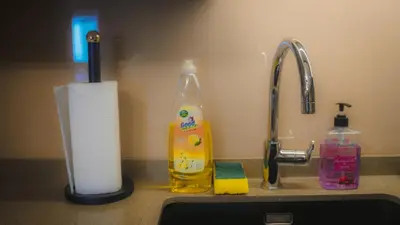 a sink with a roll of paper towels next to a faucet at Imperial Residences KLCC - JD World Homestay in Kuala Lumpur