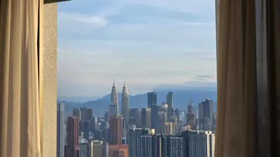a view of a city skyline from a window at Trion KL Skyline Suites in Kuala Lumpur
