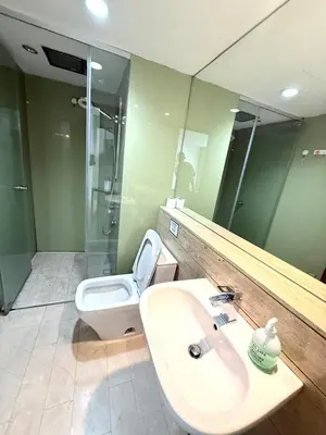 a bathroom with a sink and a toilet and a mirror at Vortex Suites klcc by Natasya in Kuala Lumpur