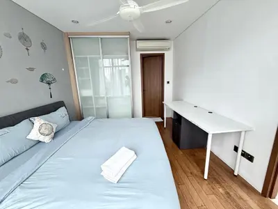 a bedroom with a white bed and a desk at Vortex Suites klcc by Natasya in Kuala Lumpur