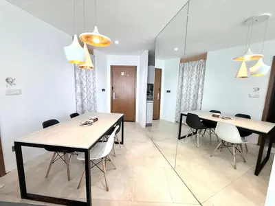 a dining room with two tables and chairs at Vortex Suites klcc by Natasya in Kuala Lumpur