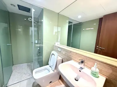 a bathroom with a toilet and a sink and a shower at Vortex Suites klcc by Natasya in Kuala Lumpur