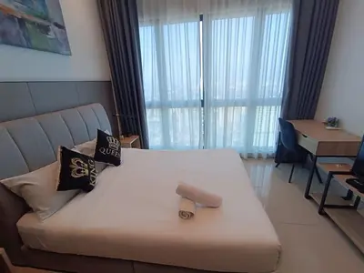 a bedroom with a bed with a large window at The Wisma INFINITUM BY KL in Kuala Lumpur