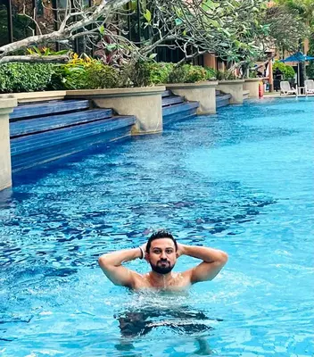 a man in a swimming pool in the water at Max suites in Kuala Lumpur