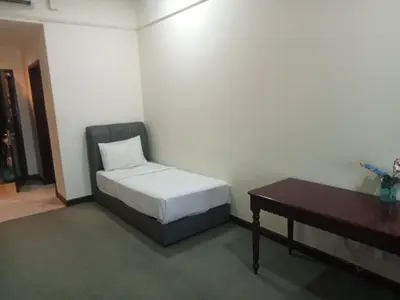a bedroom with a bed and a desk and a table at Max suites in Kuala Lumpur