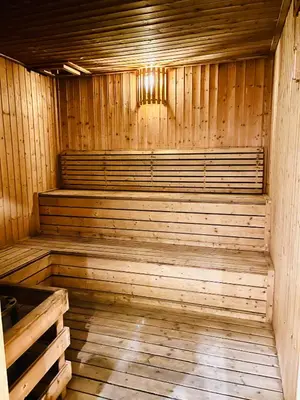 an empty wooden sauna with a chandelier in it at Max suites in Kuala Lumpur