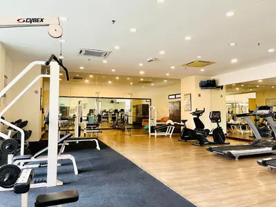 a gym with several treadmills and machines in it at Max suites in Kuala Lumpur