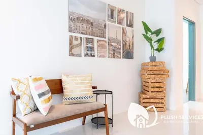 a room with a bench and a plant on a wall at Summer Suites Residences KLCC in Kuala Lumpur