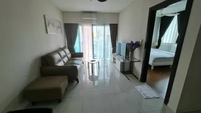 a living room with a couch and a bed at Summer Suites Residences KLCC in Kuala Lumpur