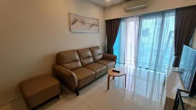 a living room with a couch and a table at Summer Suites Residences KLCC in Kuala Lumpur