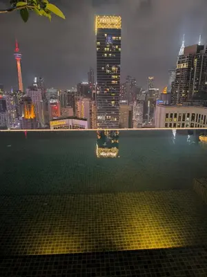 a view of a city skyline from a pool at The Bukit Bintang Near pavilion Axon Residence KL in Kuala Lumpur