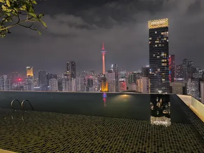 a view of a city skyline at night at The Bukit Bintang Near pavilion Axon Residence KL in Kuala Lumpur
