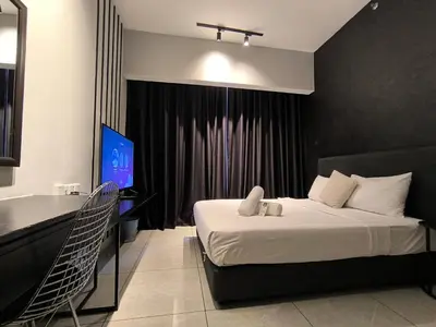 a bedroom with a bed and a desk and a television at The Bukit Bintang Near pavilion Axon Residence KL in Kuala Lumpur