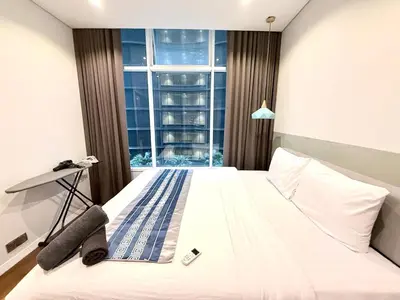 a bedroom with a bed and a large window at sky suites klcc by Natasya in Kuala Lumpur