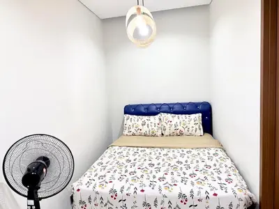 a bedroom with a bed and a fan at sky suites klcc by Natasya in Kuala Lumpur