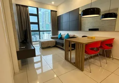 a living room with a table and a couch at Robertson By Sahara Urban Oasis in Kuala Lumpur
