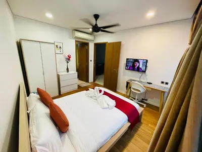 a bedroom with a bed and a desk with a computer at Vortex Suites klcc \u975e\u5e38\u8212\u9002\u7684\u4f4f\u5bbf in Kuala Lumpur