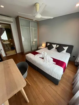 a bedroom with a large bed and a table at Vortex Suites klcc \u975e\u5e38\u8212\u9002\u7684\u4f4f\u5bbf in Kuala Lumpur