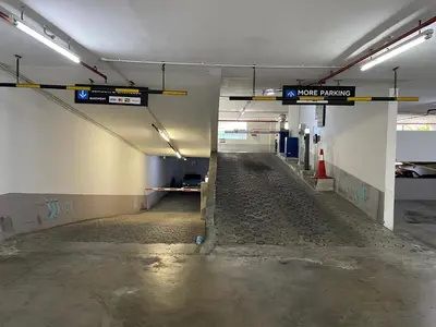 an empty parking lot with a sign in a parking garage at Vortex Suites klcc \u975e\u5e38\u8212\u9002\u7684\u4f4f\u5bbf in Kuala Lumpur