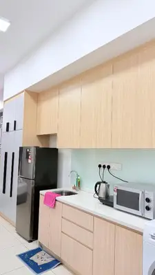 a kitchen with a refrigerator and a microwave at Colony Luxe By Swift Homes in Kuala Lumpur
