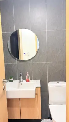 a bathroom with a sink and a mirror at Colony Luxe By Swift Homes in Kuala Lumpur