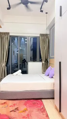 a bedroom with two beds and a large window at Colony Luxe By Swift Homes in Kuala Lumpur