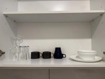 a kitchen counter with various glass items on it at Aurora by comfort in Kuala Lumpur