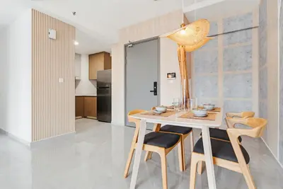 a kitchen and dining room with a table and chairs at Earthy 2BR @ Agile BB | Wi-Fi + Netflix in Kuala Lumpur