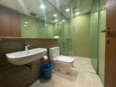 a bathroom with a sink and a toilet and a shower at Sky Suits By White Houze in Kuala Lumpur