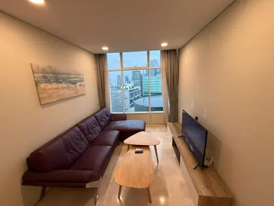 a living room with a couch and a tv and a table at Sky Suits By White Houze in Kuala Lumpur