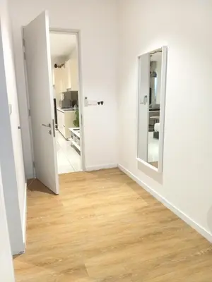 an empty room with white walls and wooden floors at Quill Residence relax Suites KLCC in Kuala Lumpur