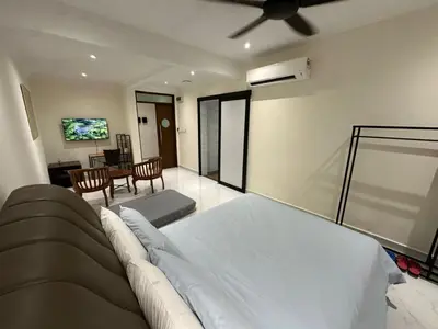 a bedroom with a bed and a living room at My Kamar Kamar in Kuala Lumpur