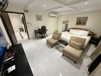 a bedroom with a bed and a desk and chairs at My Kamar Kamar in Kuala Lumpur