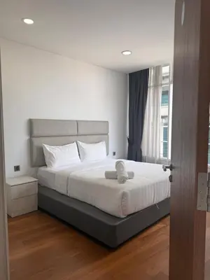 a bedroom with a bed with a stuffed animal on it at Vortex KLCC in Kuala Lumpur